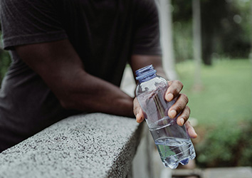 hand holding plastic water bottle