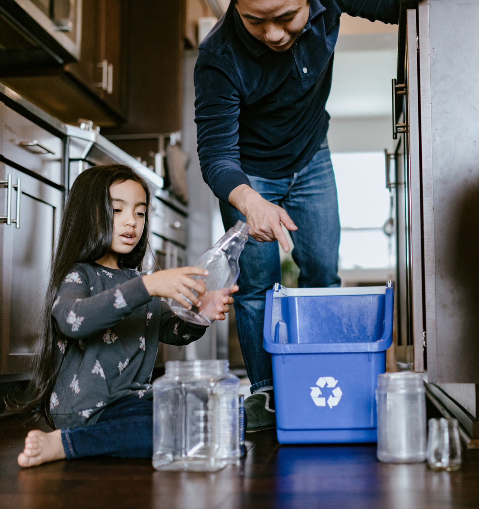Father Teaching His Daughter About Recycling, a good learning opportunity about environmental conservation and care