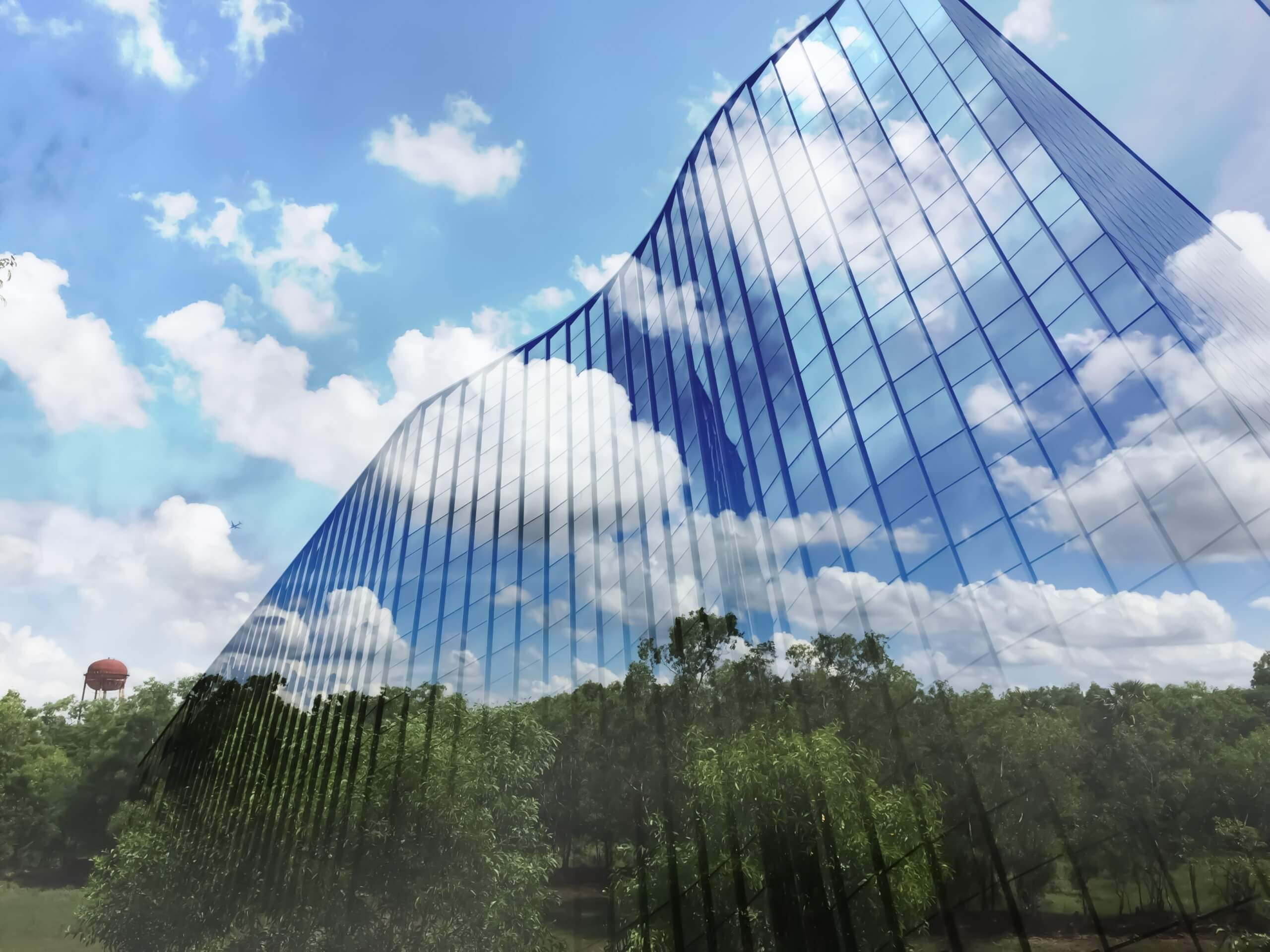 Building using plastic materials is overlaid on a green environment reflecting low climate impact